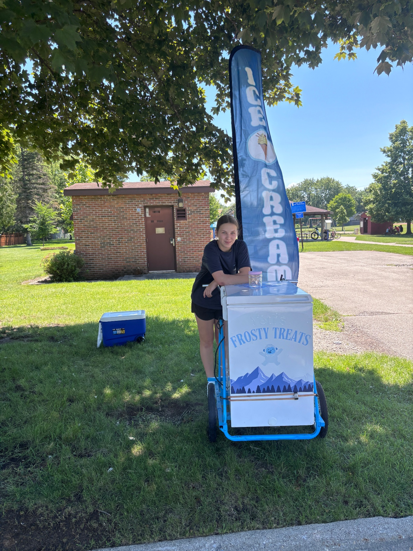 Yeti's Frosty Treats bike set up in the park with an ice cream flag
