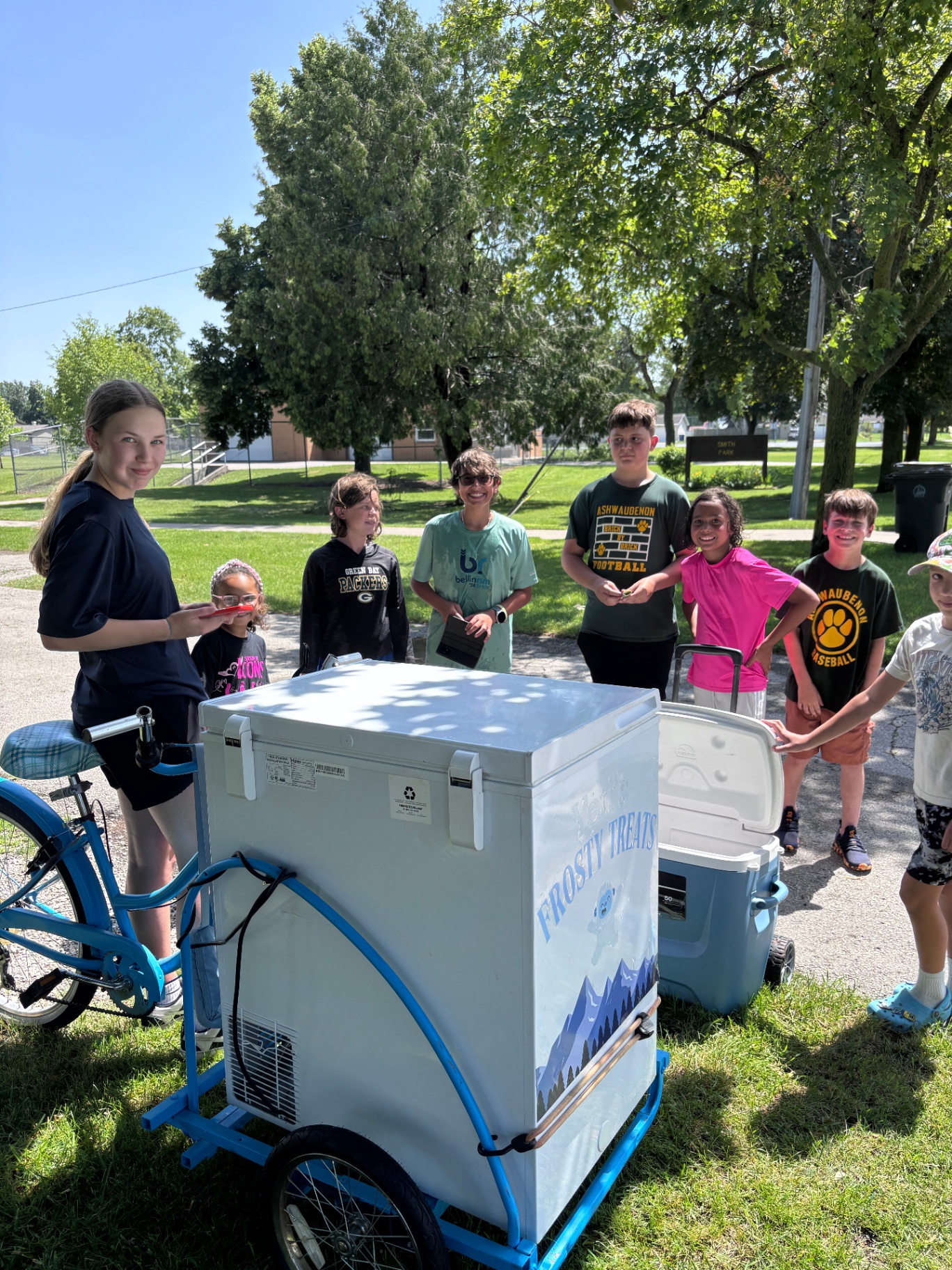 Neighborhood kids gathered around the Yeti's Frosty Treats bike at the park